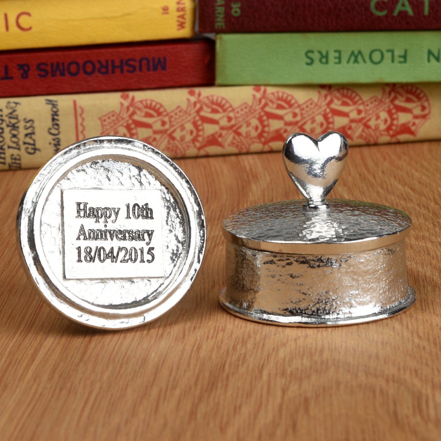 Tin Gifts. Heart 10th wedding anniversary pewter personalised trinket box gift. Our round anniversary keepsake box features a heart sculpture as a handle. The underside of the lid can be engraved with your message. A perfect tin ten year anniversary gift (Our pewter is 95% tin)