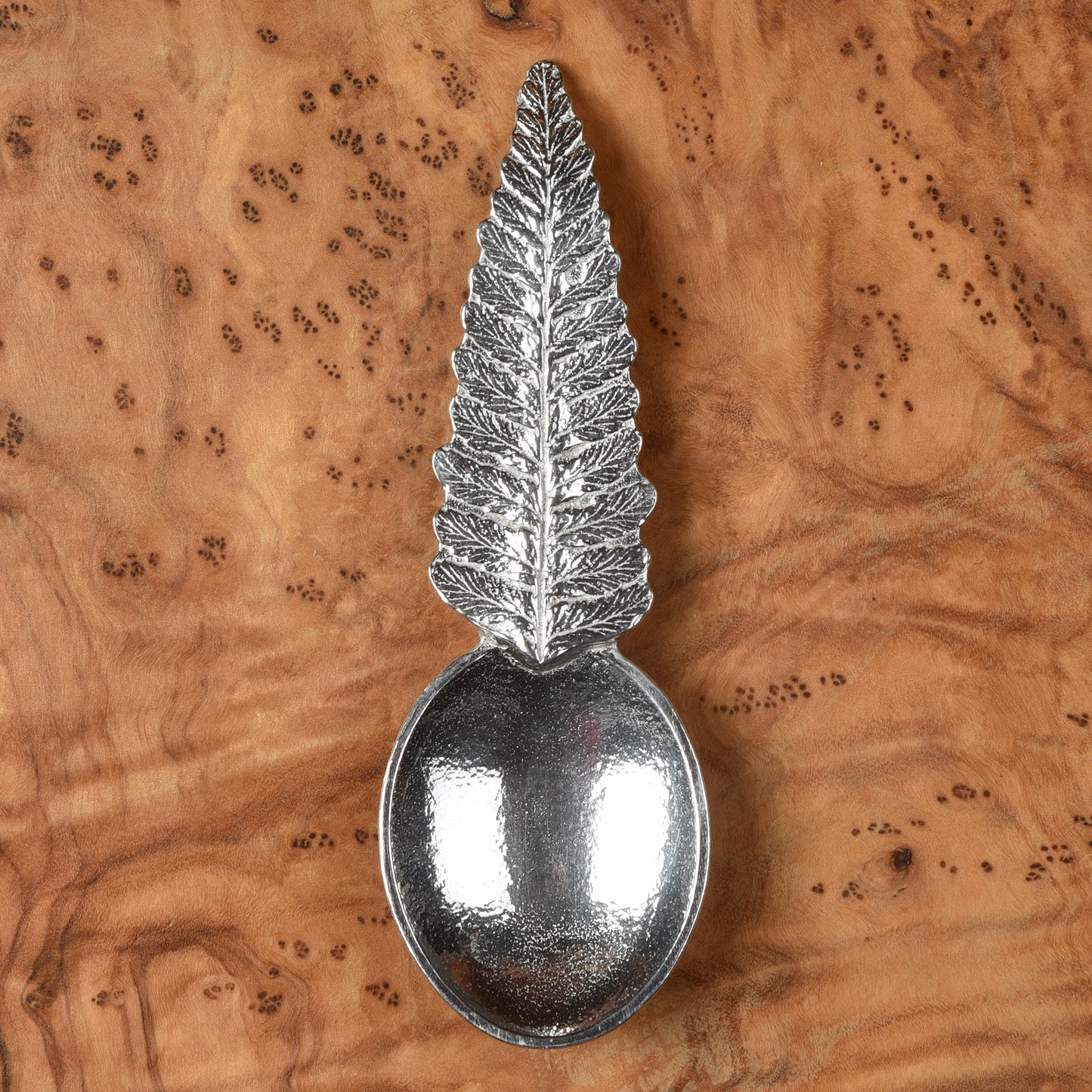 Pewter tea or coffee caddy spoon with a fern leaf handle and an oval spoon bowl. Contemporary modern pewter spoon
