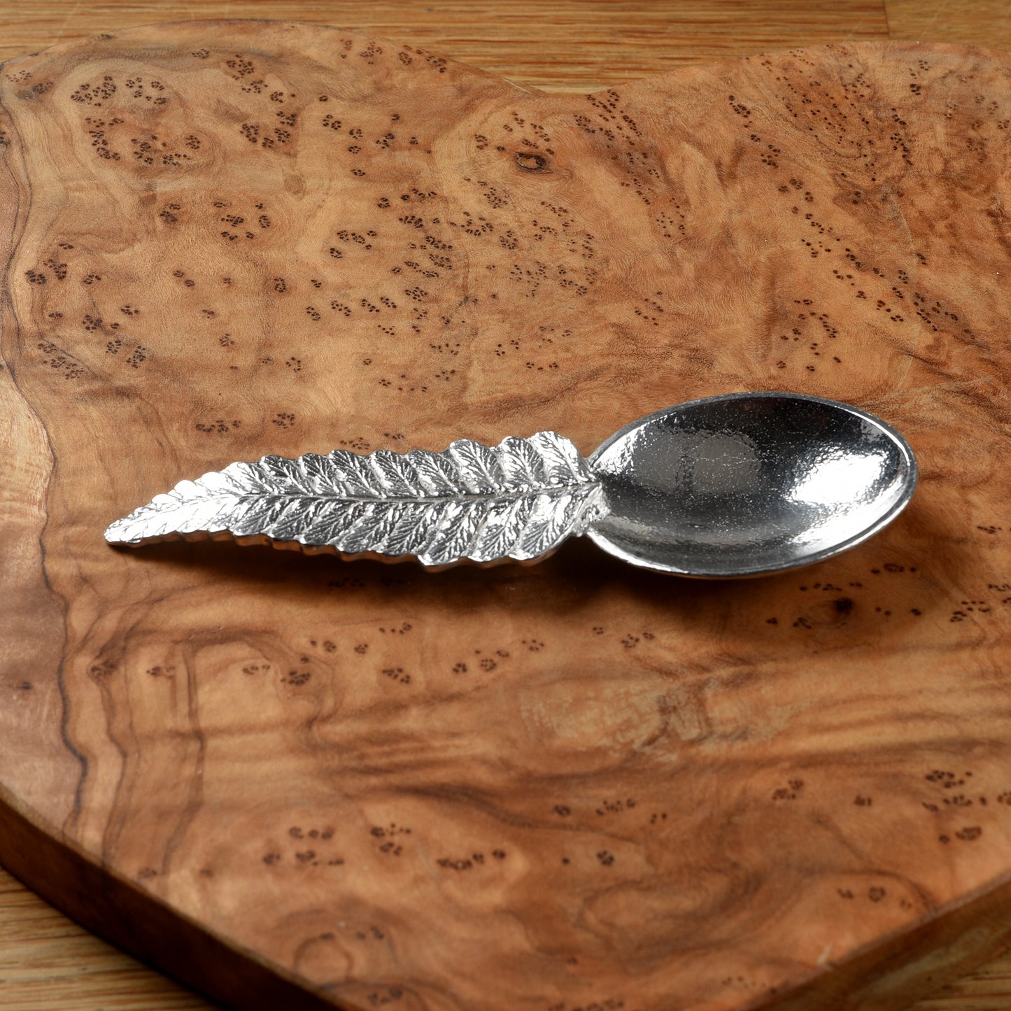 Pewter tea or coffee caddy spoon with a fern leaf handle and an oval spoon bowl. Contemporary modern pewter spoon