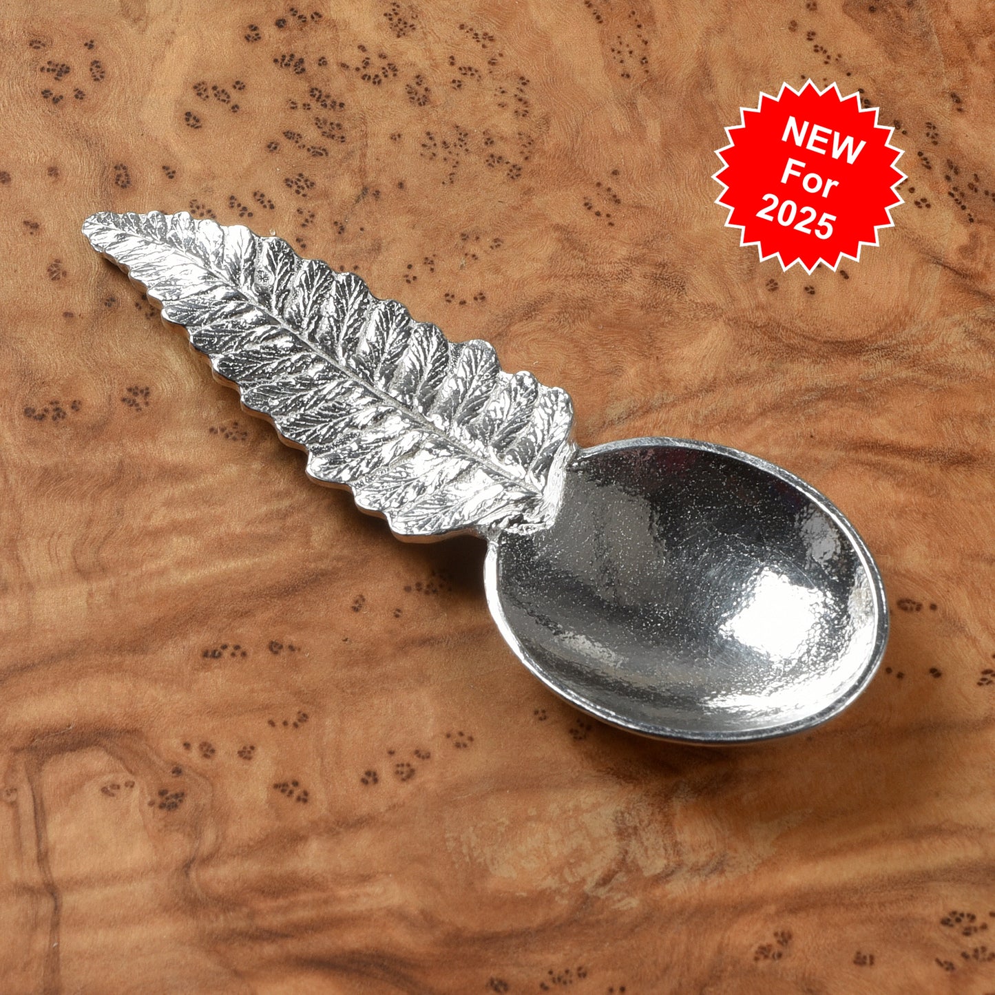 Pewter tea or coffee caddy spoon with a fern leaf handle and an oval spoon bowl. Contemporary modern pewter spoon
