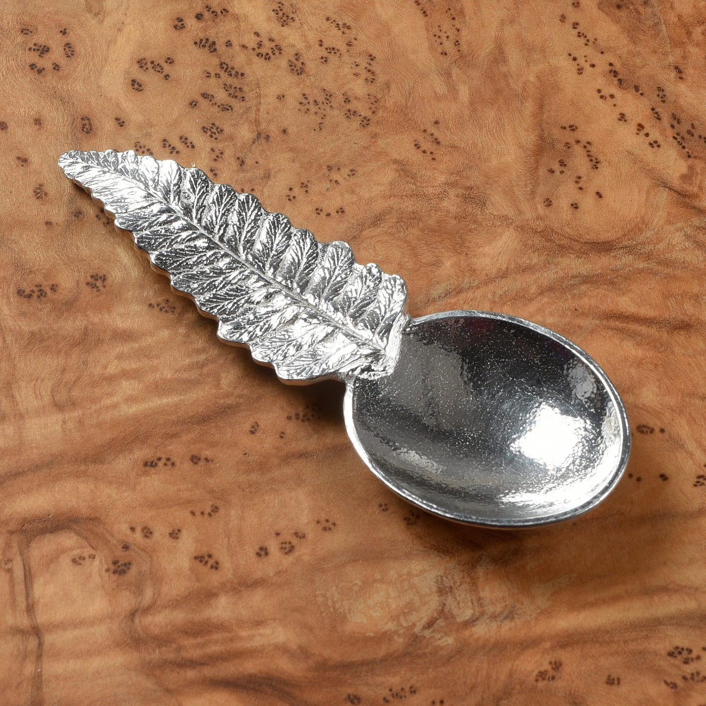 Pewter tea or coffee caddy spoon with a fern leaf handle and an oval spoon bowl. Contemporary modern pewter spoon
