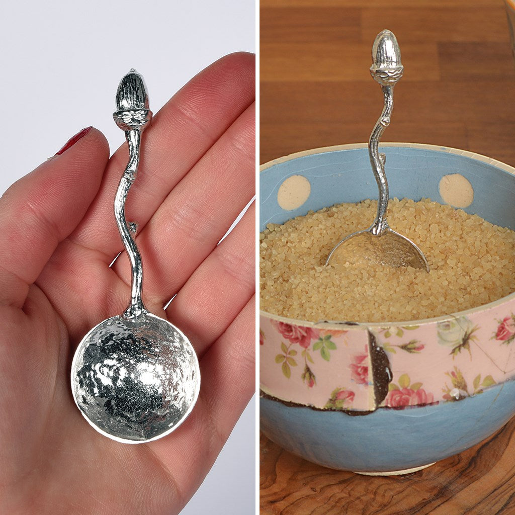 A small spoon pewter sugar spoon with an acorn on the end of a twig handle. Unusual, useful and tactile little acorn gifts handmade in the UK