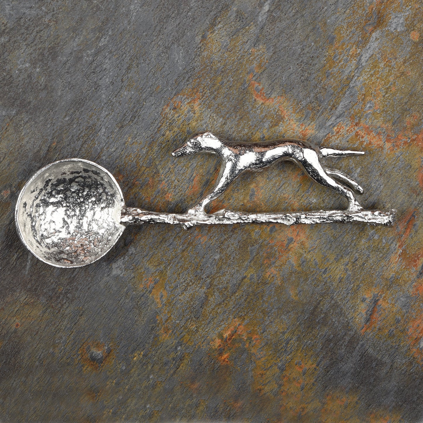 Greyhound pewter sugar spoon, A sleek greyhound runs along a branch to form the spoon handle. With a round spoon bowl. Gifts for dog lovers.