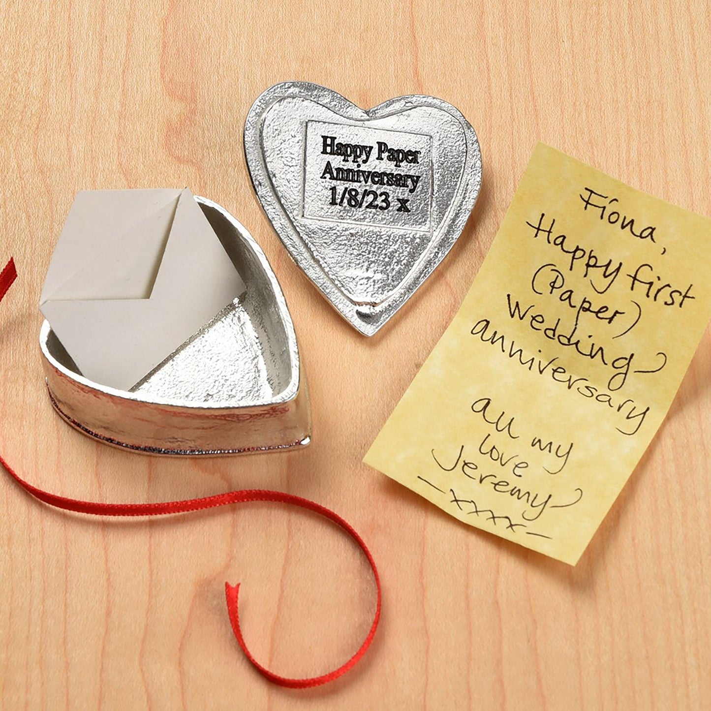 A personalised heart shaped pewter keepsake box with a garnet stone in the middle. The underside of the lid can be engraved with your personalised message. A perfect 10th (Tin) ten year wedding anniversary gift (Our pewter is 95% tin).