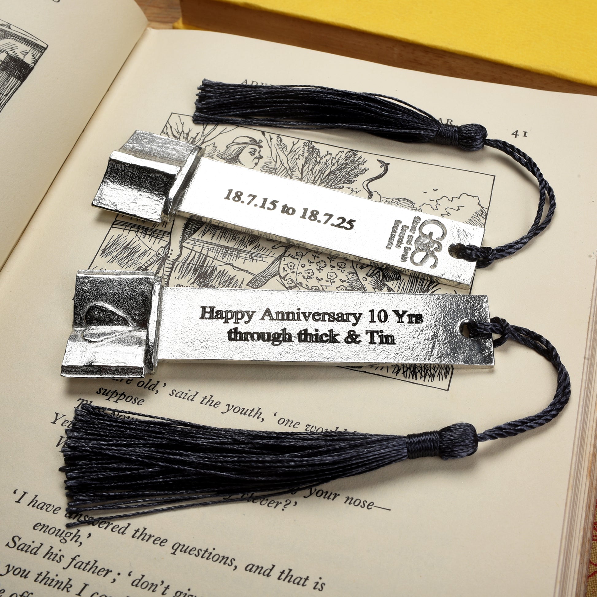 A personalised engraved pewter metal  bookmark with a heart on an open book on the top. We can engrave the front and the back with your own personalised messages. Unique gifts. Ideal 10th tin wedding anniversary gift. Our pewter is 95% tin.
