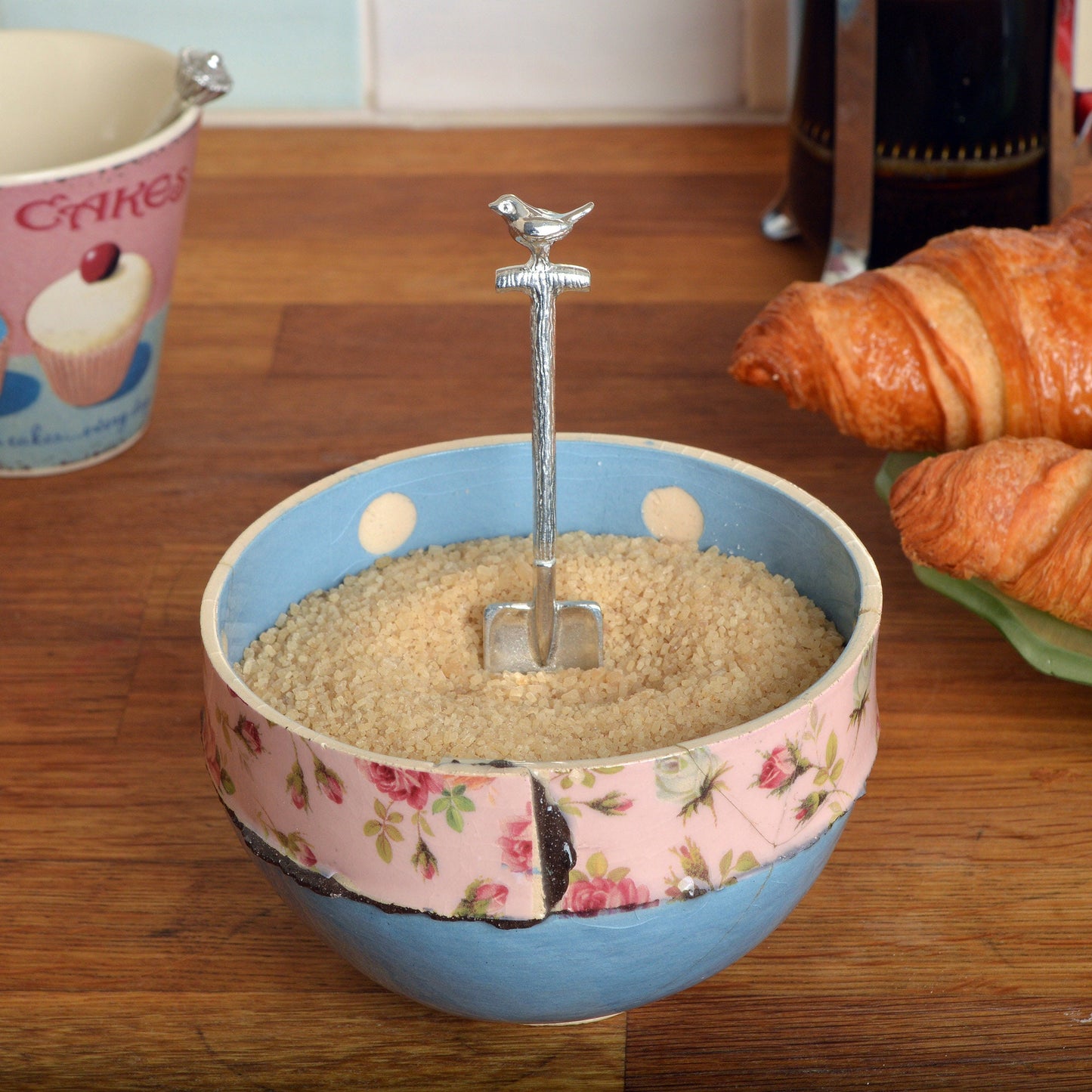A small spoon pewter sugar spoon in the shape of a garden spade with a robin sitting on the handle . Unusual, useful and tactile gifts for gardeners gifts for bird lovers handmade in the UK