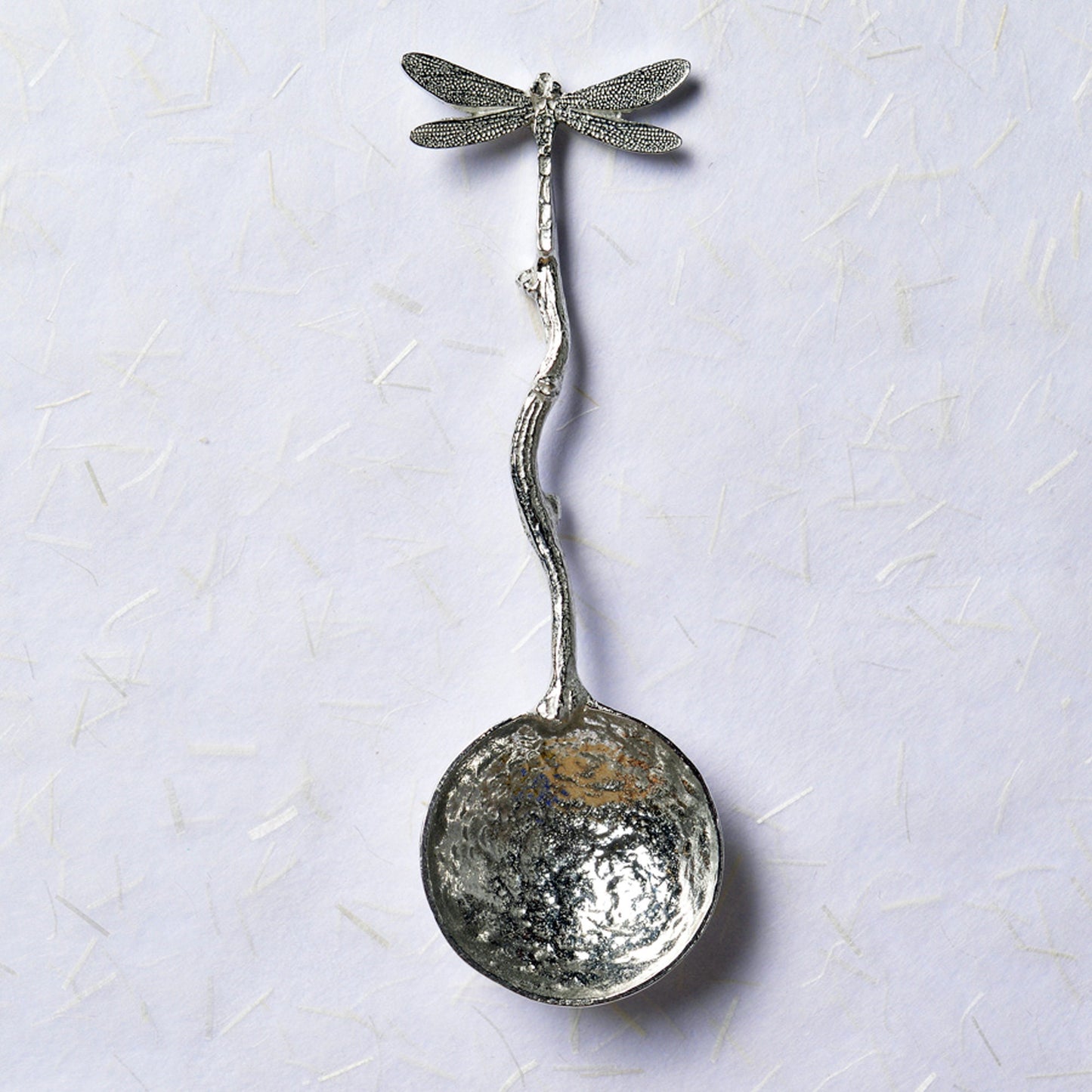 A small spoon pewter sugar spoon with a dragonfly on the end of a twig handle. Unusual, useful and tactile dragonfly gifts handmade in the UK