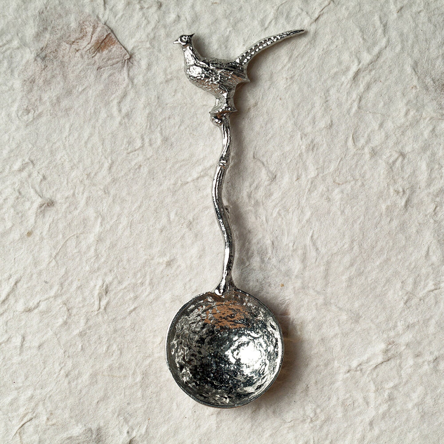 A small spoon pewter sugar spoon with a detailed pheasant on a twig handle. Unusual, useful and tactile gifts for nature lovers, pheasant shooting gifts handmade in the UK useful countryside gifts