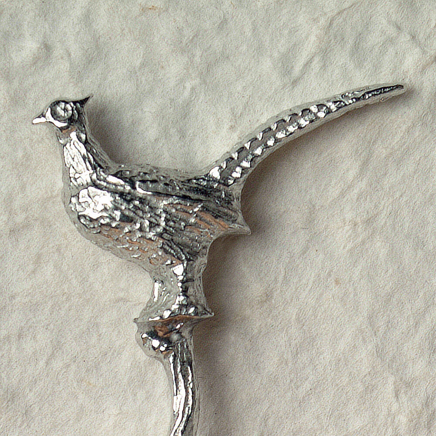 A small spoon pewter sugar spoon with a detailed pheasant on a twig handle. Unusual, useful and tactile gifts for nature lovers, pheasant shooting gifts handmade in the UK useful countryside gifts