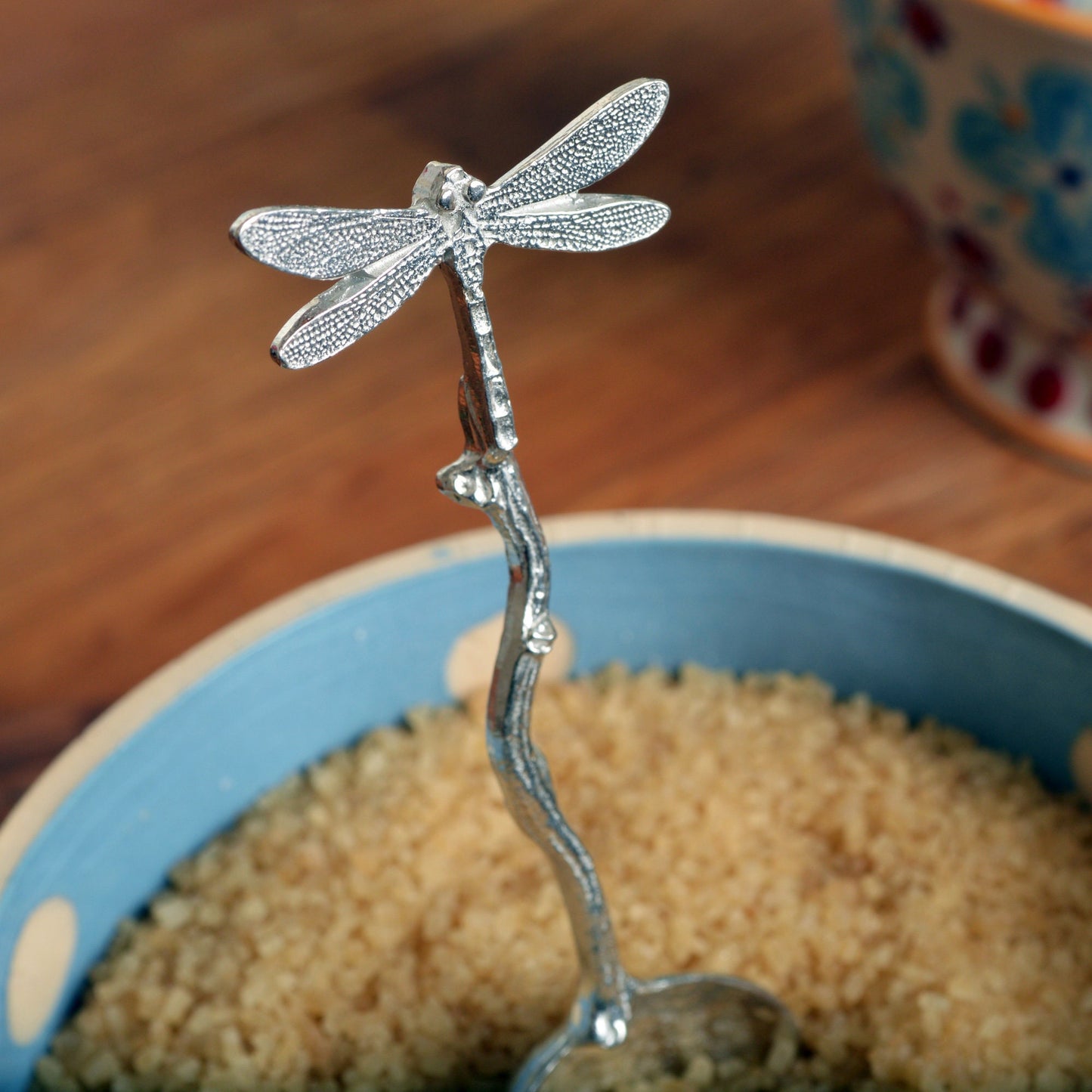 A small spoon pewter sugar spoon with a dragonfly on the end of a twig handle. Unusual, useful and tactile dragonfly gifts handmade in the UK