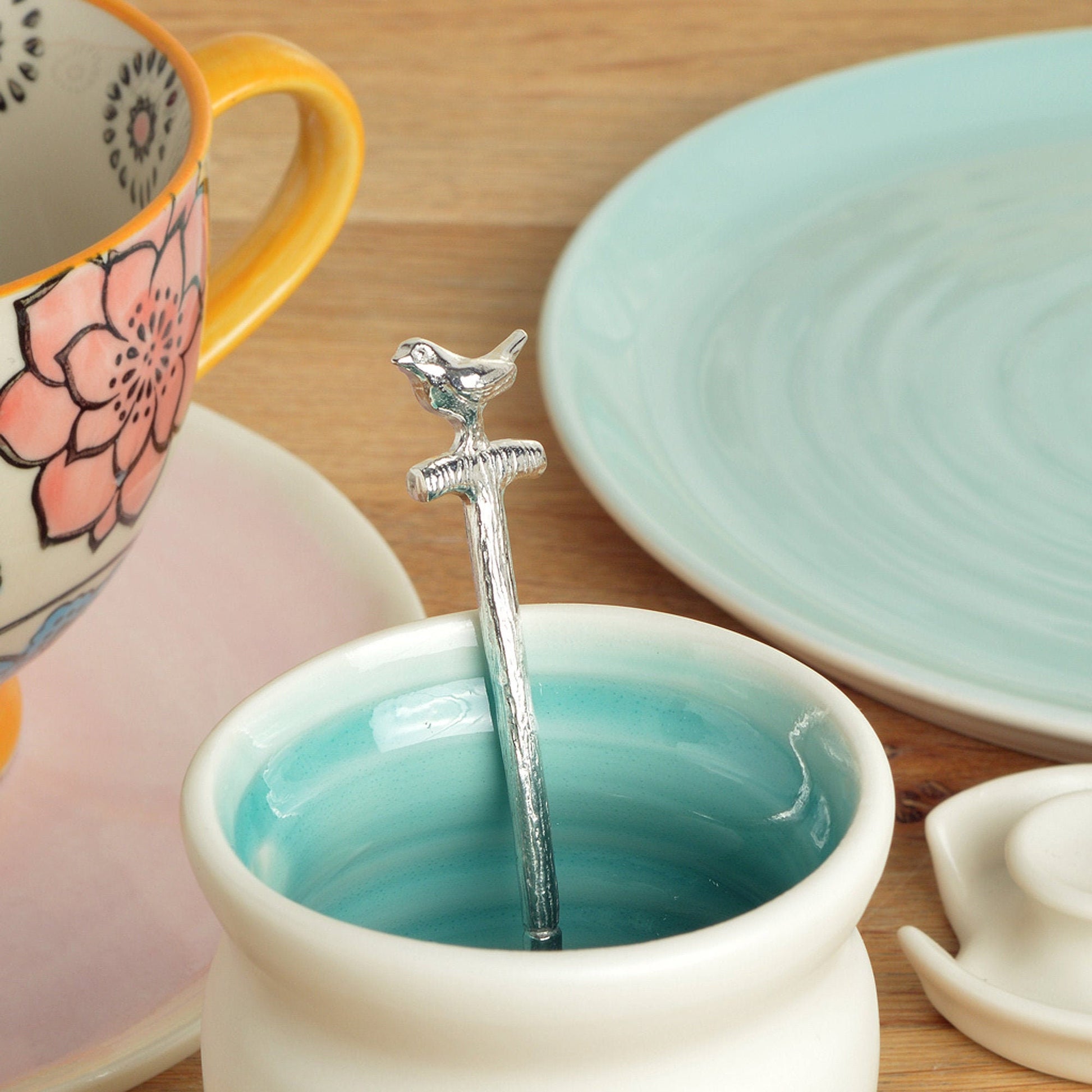 A small spoon pewter sugar spoon in the shape of a garden spade with a robin sitting on the handle . Unusual, useful and tactile gifts for gardeners gifts for bird lovers handmade in the UK
