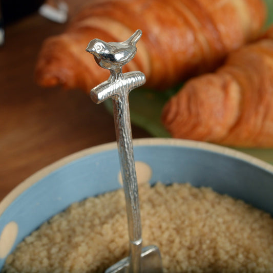 A small spoon pewter sugar spoon in the shape of a garden spade with a robin sitting on the handle . Unusual, useful and tactile gifts for gardeners gifts for bird lovers handmade in the UK