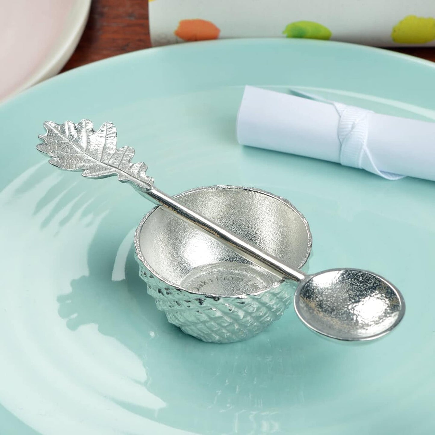 Our pewter 'Acorn Cup' egg cup features the lovely natural texture and pattern of an acorn cup and when an egg is placed in it, has the appearance of an acorn. With an oak leaf topped spoon. Christening gifts for boys and girls.