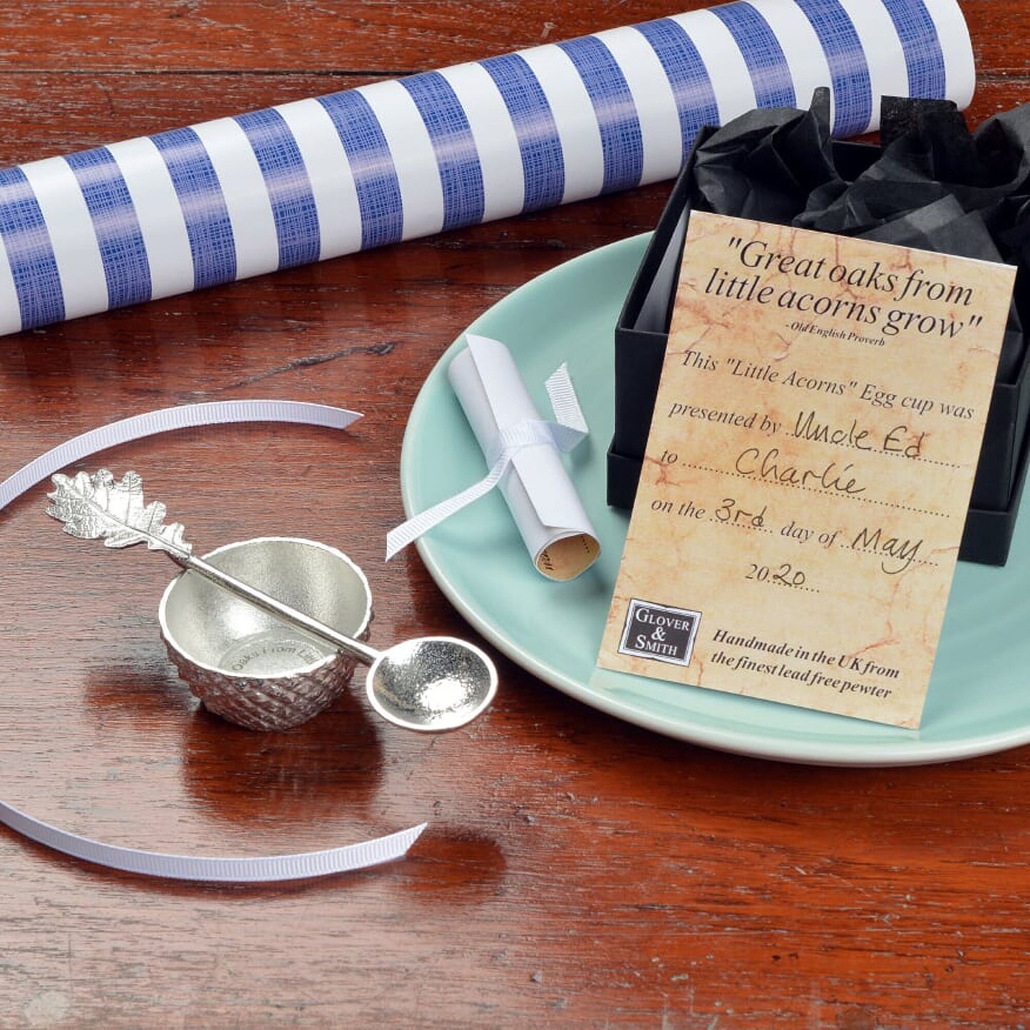 Our pewter 'Acorn Cup' egg cup features the lovely natural texture and pattern of an acorn cup and when an egg is placed in it, has the appearance of an acorn. With an oak leaf topped spoon. Christening gifts for boys and girls.