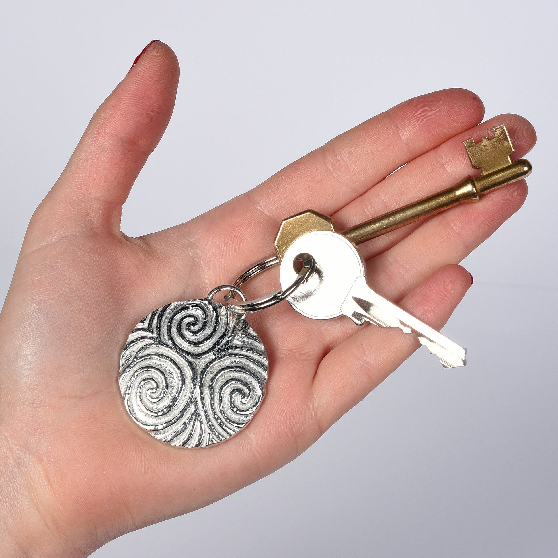 A detailed & pleasingly textured pewter Neolithic Spiral of Life relief keyring on a stainless steel ring. Triskelion key ring, spiral of life gifts, pewter keyring gifts. Housewarming gifts.