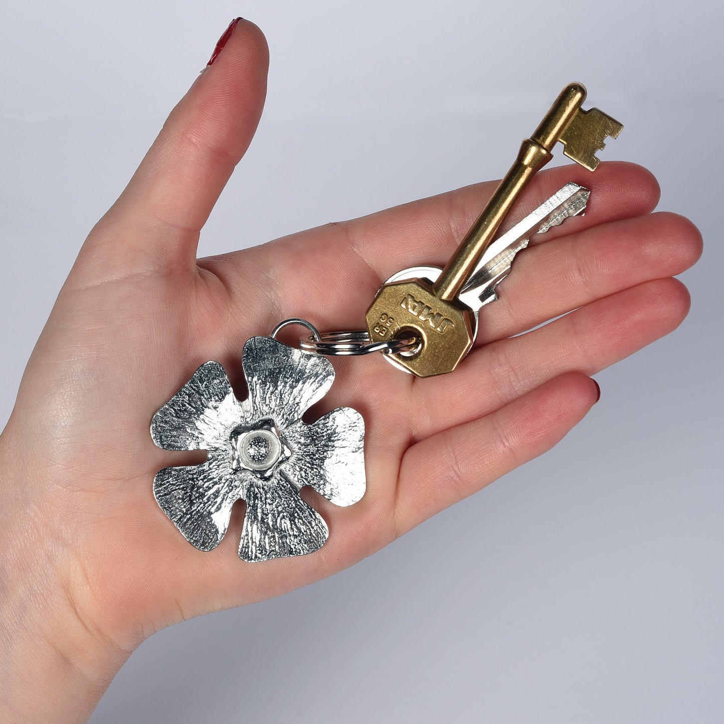 A solid pewter flower shaped keyring on a quality stainless steel ring. Love tokens, new home gifts, useful gifts, gifts for nature lovers, forget me not gifts, housewarming gifts, handmade in the UK