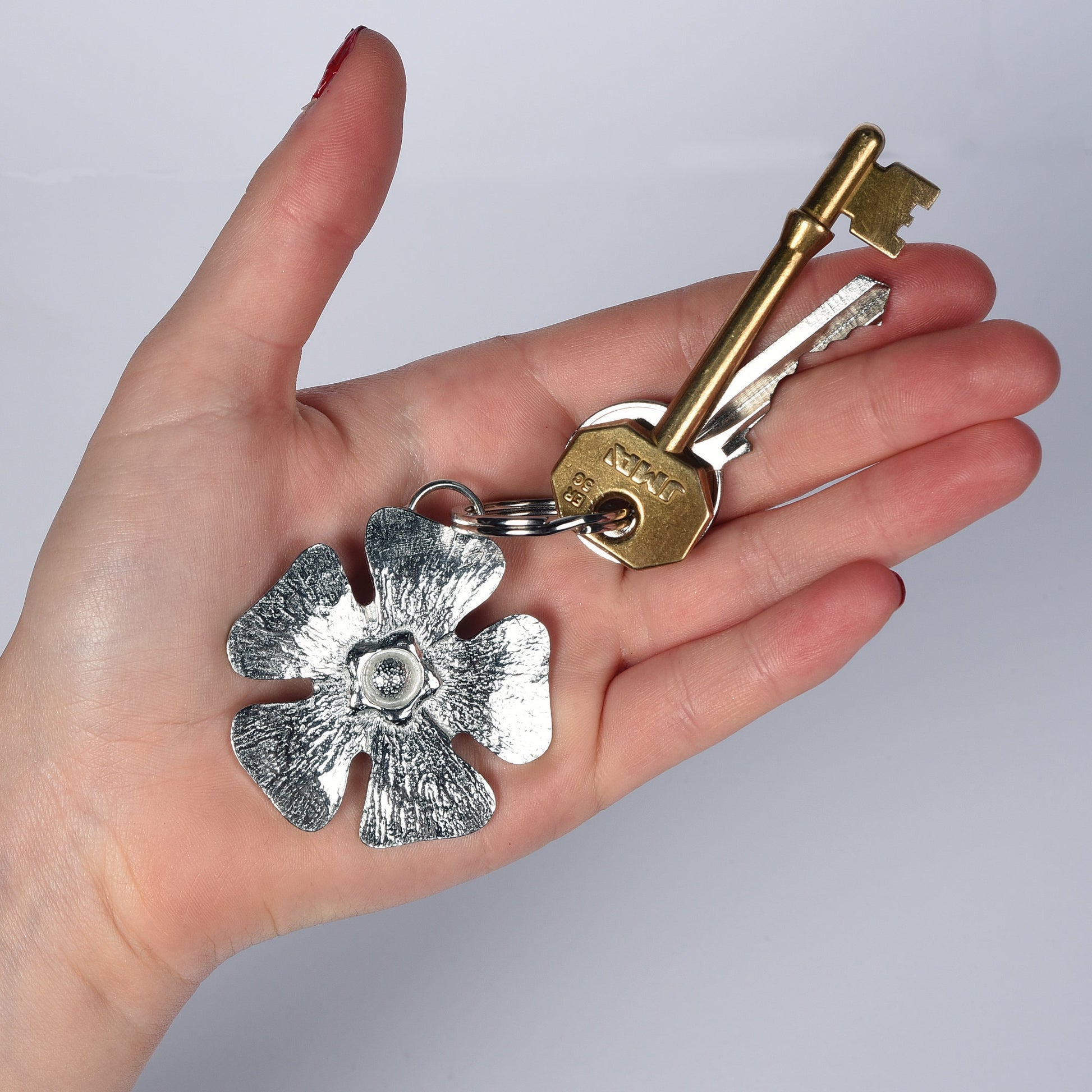 A solid pewter flower shaped keyring on a quality stainless steel ring. Love tokens, new home gifts, useful gifts, gifts for nature lovers, forget me not gifts, housewarming gifts, handmade in the UK