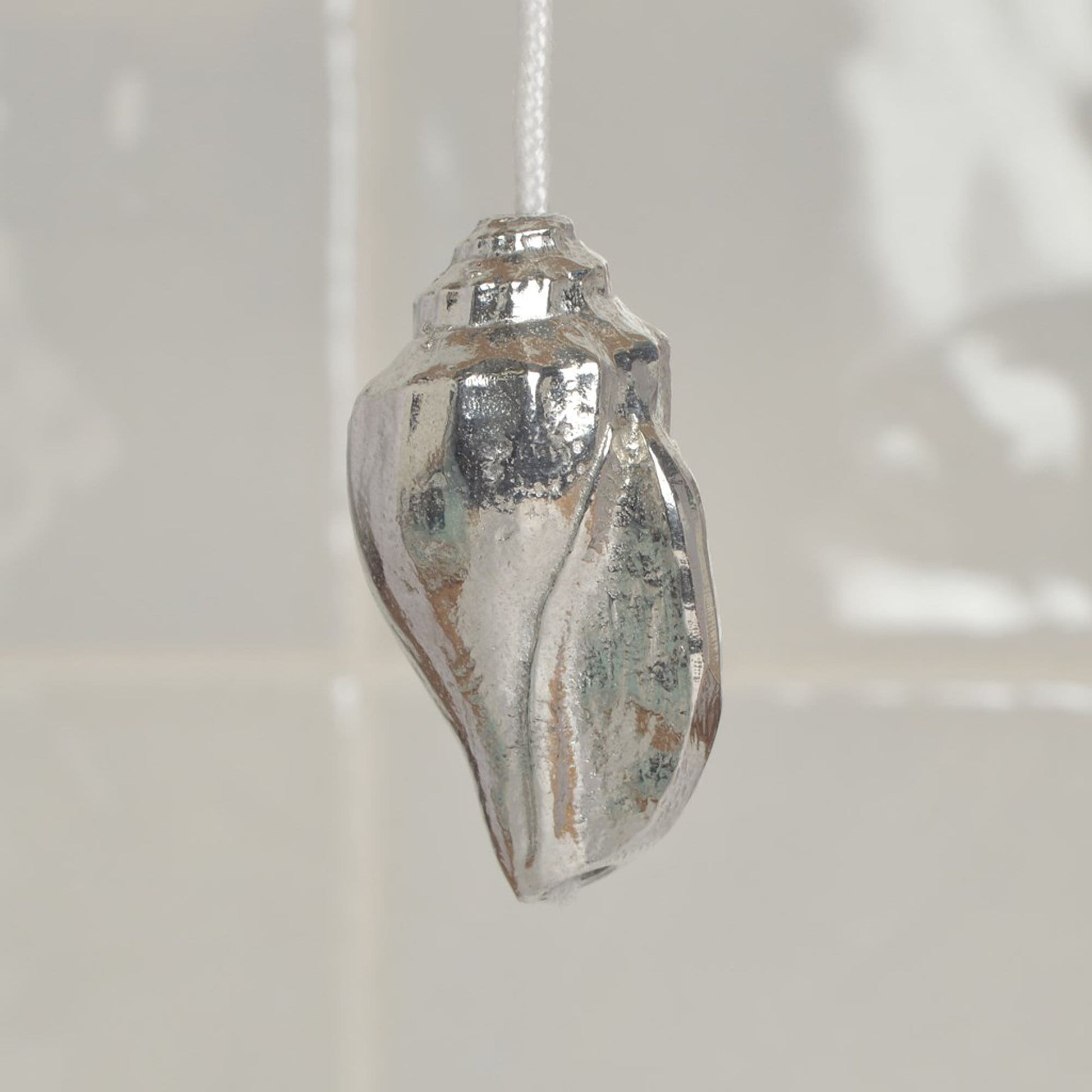 Sea shell bathroom light pull or cord pull. A tactile and decorative pewter sea shell hangs at the bottom of the bathroom light switch cord. ideal little housewarming gifts.