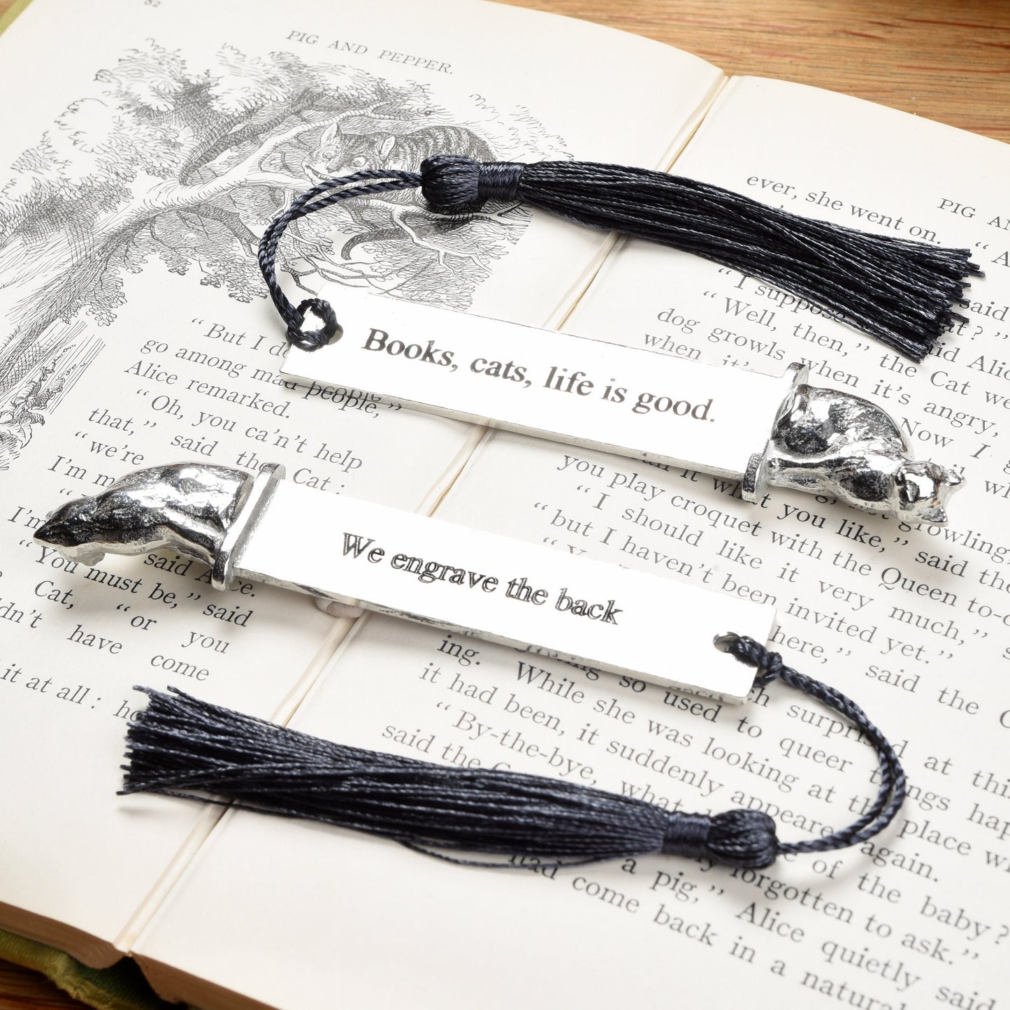 A personalized engraved pewter metal bookmark with a cat sculpture on the top. On the front the quotation 'Books, cats, life is good'. We engrave the back with your message. Gifts for cat lovers, book lovers gifts, cat gifts.