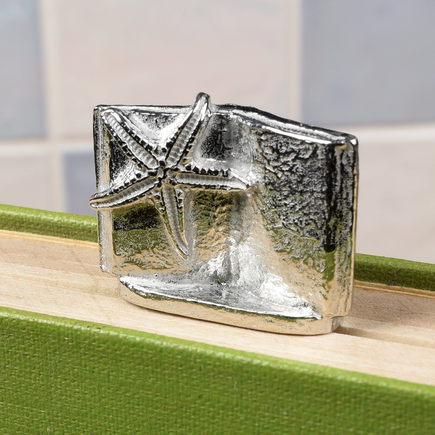 A personalised engraved pewter metal bookmark with a starfish gripping an open book on the top. On the front the quotation 'Sand between my toes & a book under my nose'. We engrave the back with your message. Holiday gifts, personalised gifts