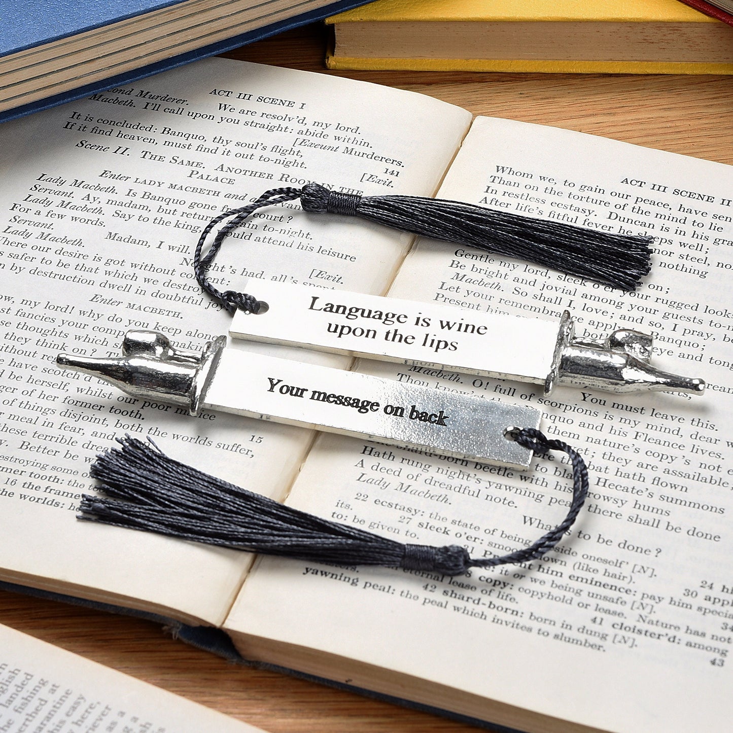 A personalised engraved pewter metal bookmark with a wine bottle and glass on the top. On the front the quotation 'Language is wine upon the lips'. We engrave the back with your message. Gifts for wine lovers, book lovers gifts.