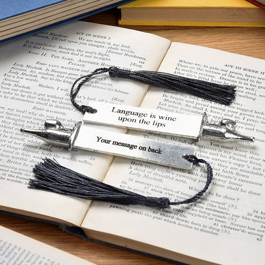 A personalised engraved pewter metal  bookmark with a wine bottle and glass on the top. On the front the quotation 'Language is wine upon the lips'. We engrave the back with your message. Gifts for wine lovers, book lovers gifts.