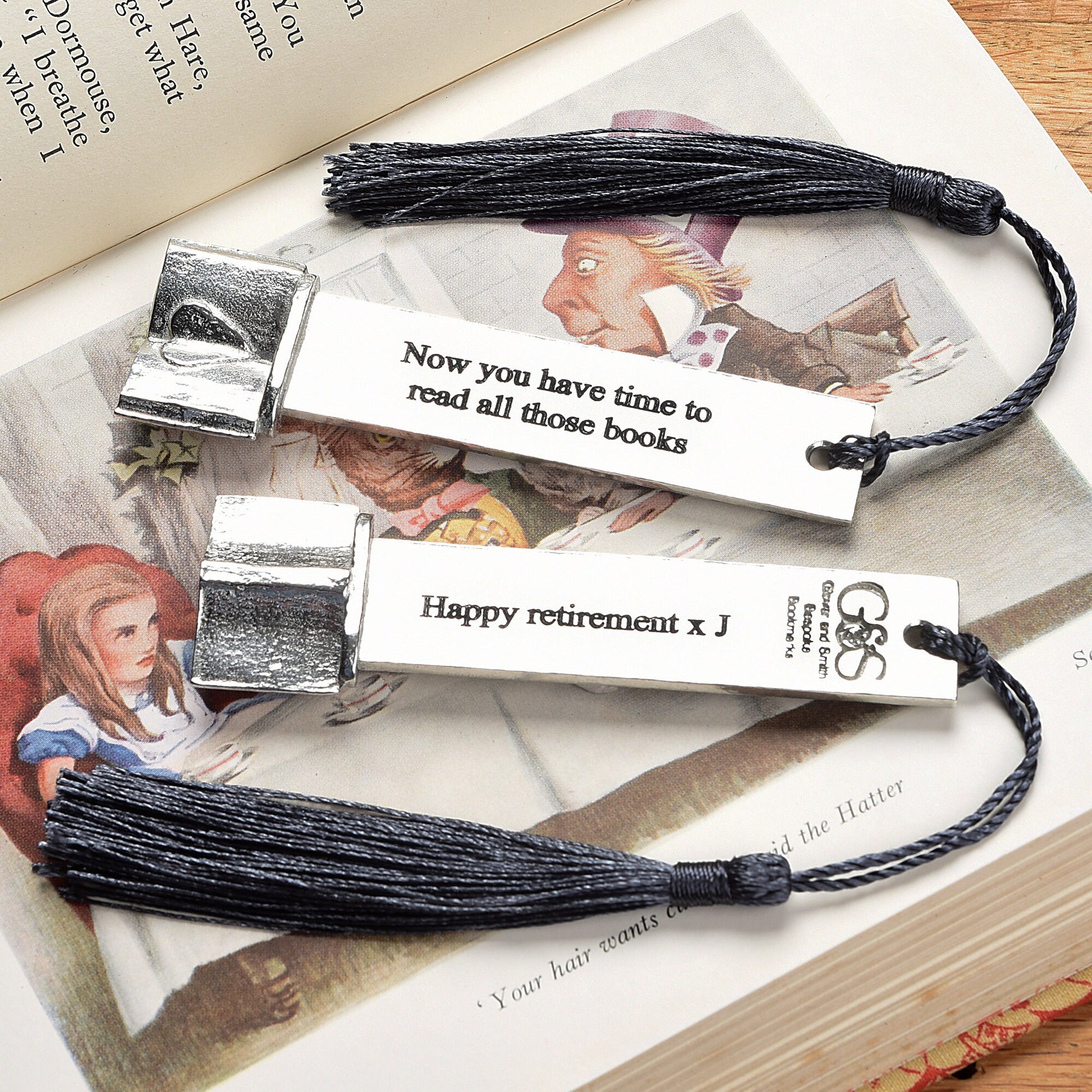 A personalised engraved pewter metal  bookmark with a heart on an open book on the top. We can engrave the front and the back with your own personalised messages. Unique gifts. Ideal 10th tin wedding anniversary gift. Our pewter is 95% tin.