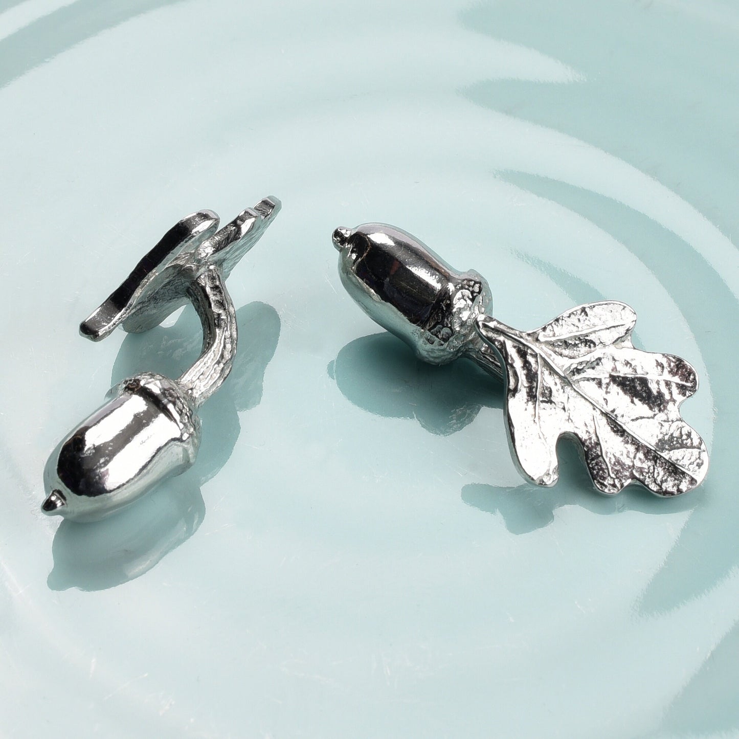 A pair of pewter acorns linked to oak leaves via twig stems make a practical and beautiful cufflinks. 'Great oaks from little acorns grow'. Christening gifts for boys for use in later life. With certificate from giver.