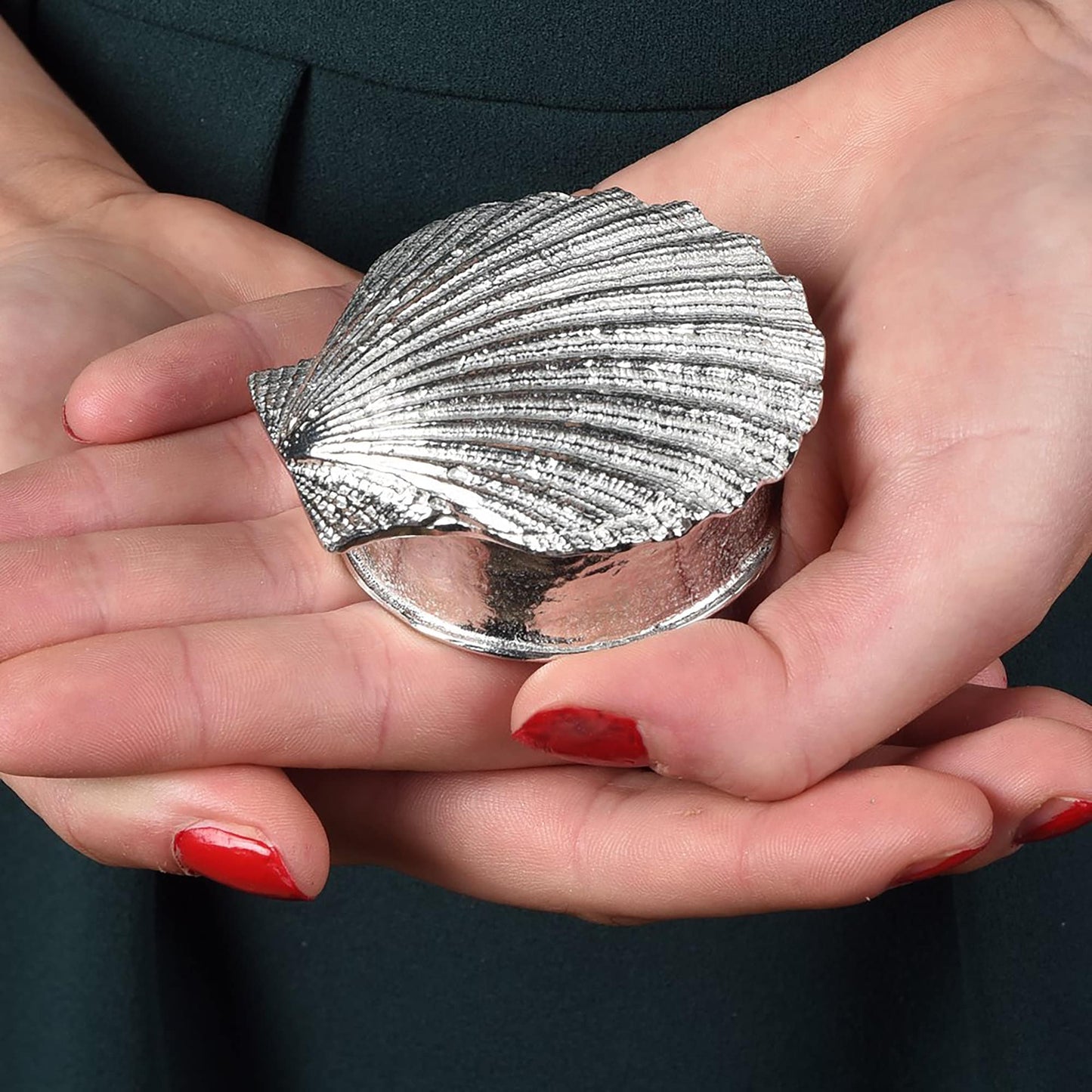 A round pewter trinket box with a scallop shell lid. Nautical gifts for lovers of the seaside and sea life.