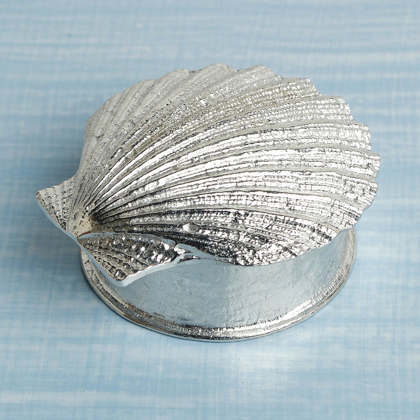 A round pewter trinket box with a scallop shell lid. Nautical gifts for lovers of the seaside and sea life.