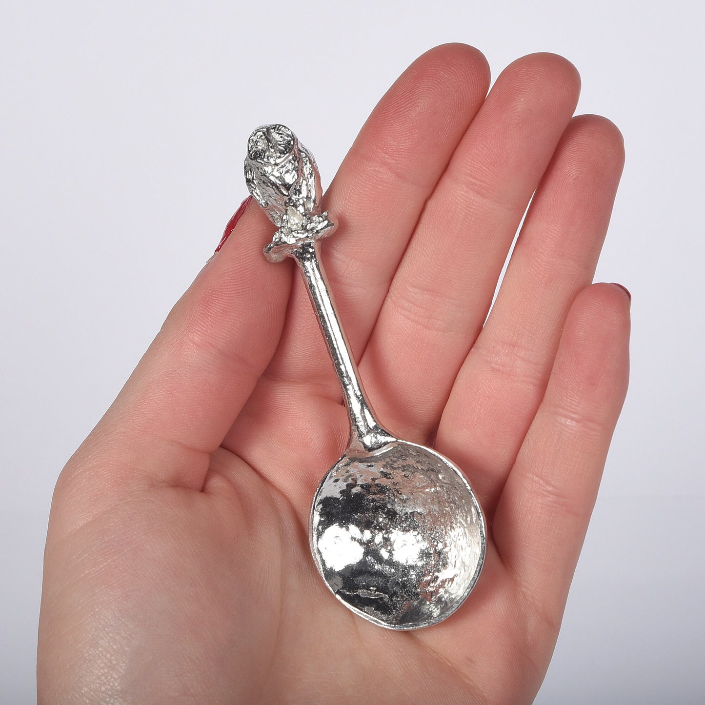 A small spoon pewter sugar spoon. A round bowled spoon on a straight handle leads to a perfectly sculpted owl. Practical & useful bird gifts for bird lovers. UK handmade