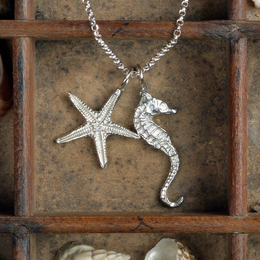 A delicate and detailed pewter seahorse and starfish necklace on an 18" Sterling silver chain. Great jewellery gifts for her, nautical gifts for starfish and seahorse lovers. The perfect 10th tin 10 year wedding anniversary gift (Our pewter is 95% tin). Made in Britain with love.
