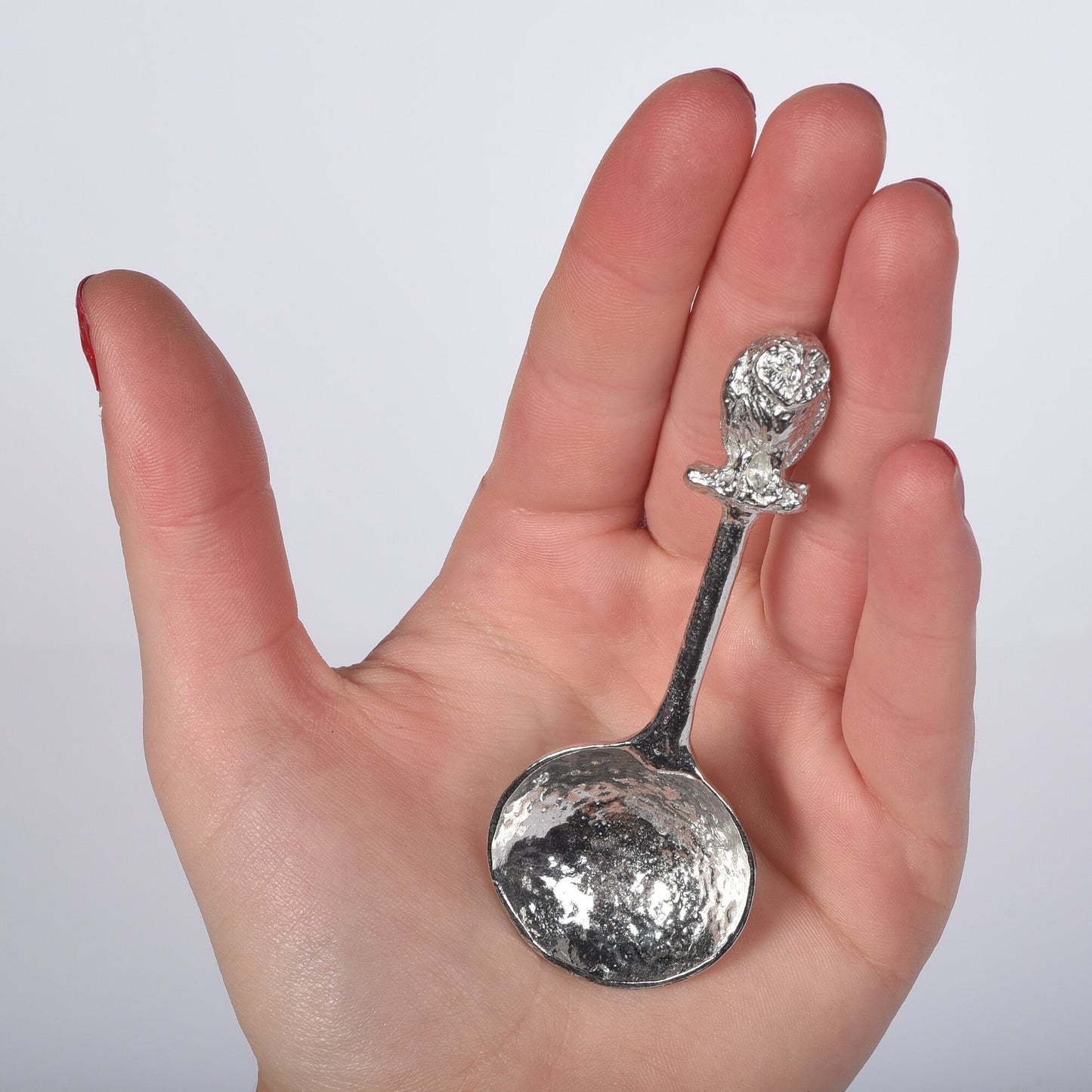 A small spoon pewter sugar spoon. A round bowled spoon on a straight handle leads to a perfectly sculpted owl. Practical & useful bird gifts for bird lovers. UK handmade