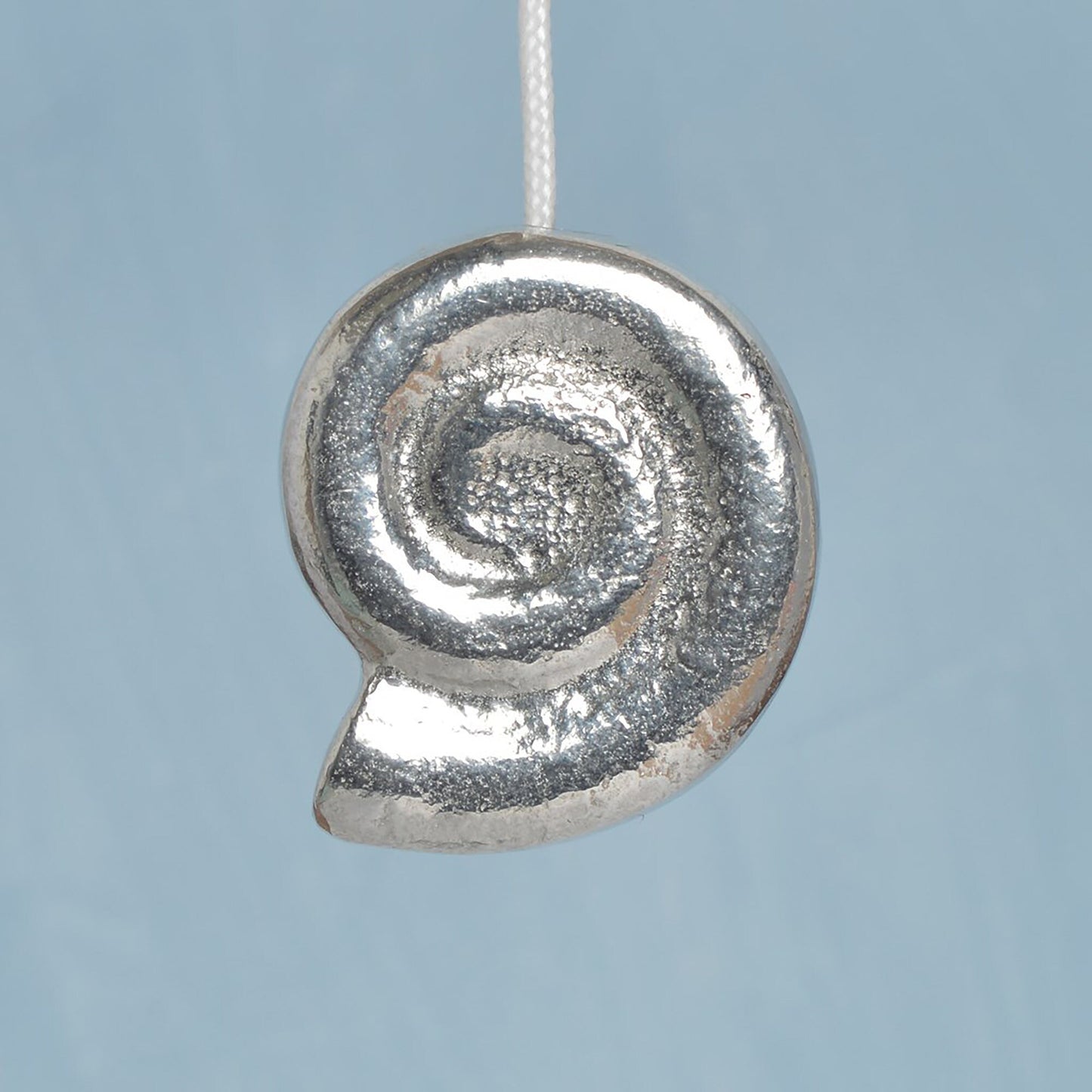 Whirley shell bathroom light pull or cord pull. A tactile and decorative pewter Whirley shell hangs at the bottom of the bathroom light switch cord. ideal little housewarming gifts.