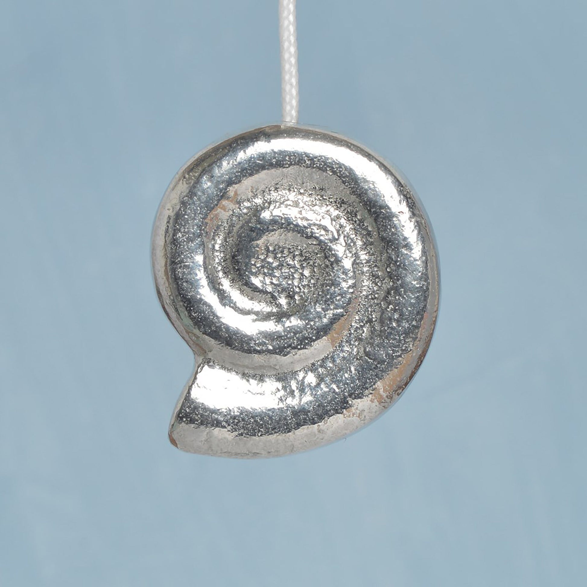 Whirley shell bathroom light pull or cord pull. A tactile and decorative pewter Whirley shell hangs at the bottom of the bathroom light switch cord. ideal little housewarming gifts.