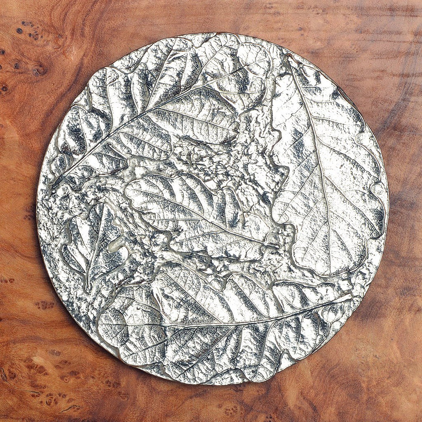 Oak leaf coaster set of 4. Each coaster is a circular composition of detailed cast oak leaves forming actractive round pewter drinks coasters. Practical and useful housewarming gifts, ideal gifts for nature lovers, UK handmade