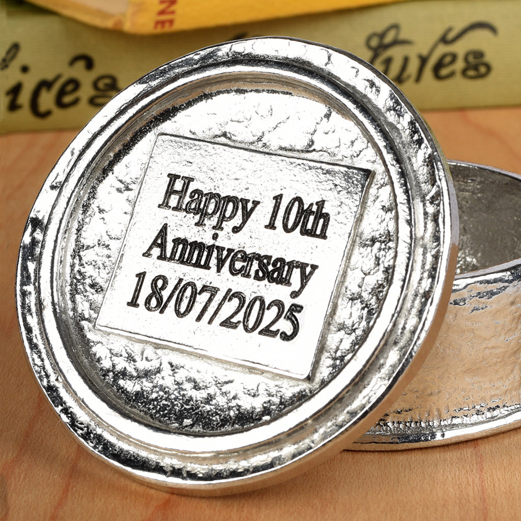 Heart 10th wedding anniversary pewter personalised trinket box gift. Our round anniversary keepsake box features a heart sculpture as a handle. The underside of the lid can be engraved with your message. A perfect tin ten year  anniversary gift (Our pewter is 95% tin)