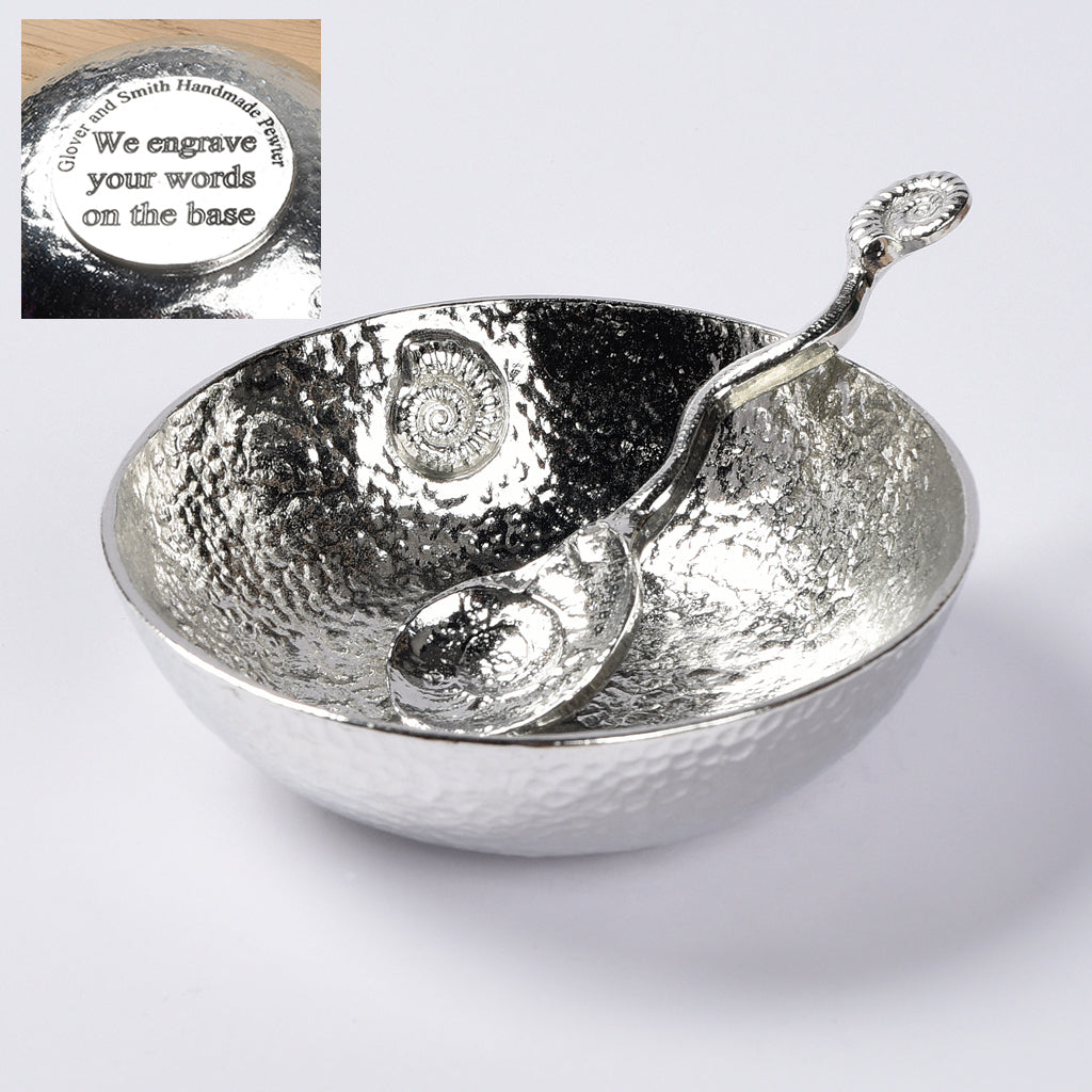 A 9cm diameter beautifully textured circular pewter bowl, with a striking, yet subtle ammonite fossil on the inside of the dish, comes with accompanying ammonite  fossil spoon. We engrave the  Gifts For Fossil Lovers. We engrave the base with your words