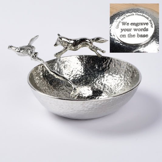 A 9cm diameter textured circular pewter bowl, with a striking fox running around the edge of the dish, comes with accompanying pheasant spoon. Great hunting and shooting gifts for lovers of the British countryside and country pursuits. We engrave the base with your message.