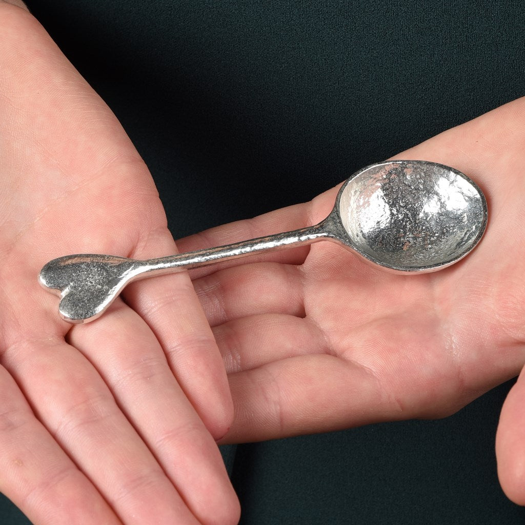 A small spoon pewter sugar teaspoon  with a love heart on the end. Our love spoon makes an ideal little love token or 10th tin wedding anniversary gift or small wedding gift.