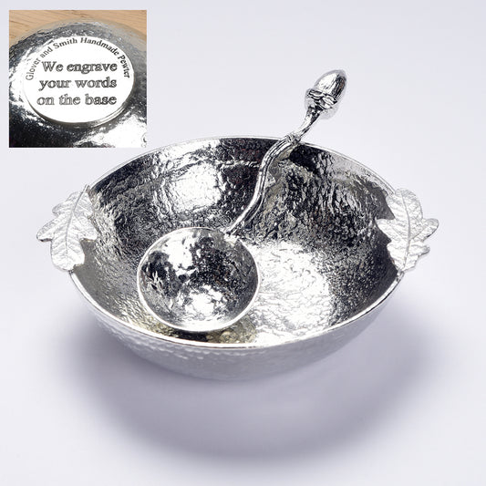 A 9cm diameter textured circular pewter bowl, with two oak leaves on the edge of the dish, comes with accompanying acorn spoon. Gifts for nature lovers, oak and acorn gifts. 'Great oaks from little acorns grow'. We engrave the base with your message.