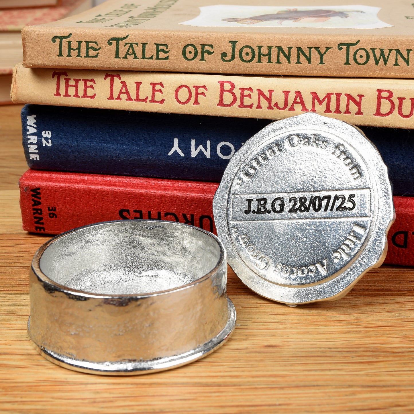 A personalised, engraved pewter little acorns box. The lid has an acorn surrounded by a garland of oak leaves. 'Great oaks from little acorns grow' is written under the lid. Christening gifts for boys and girls