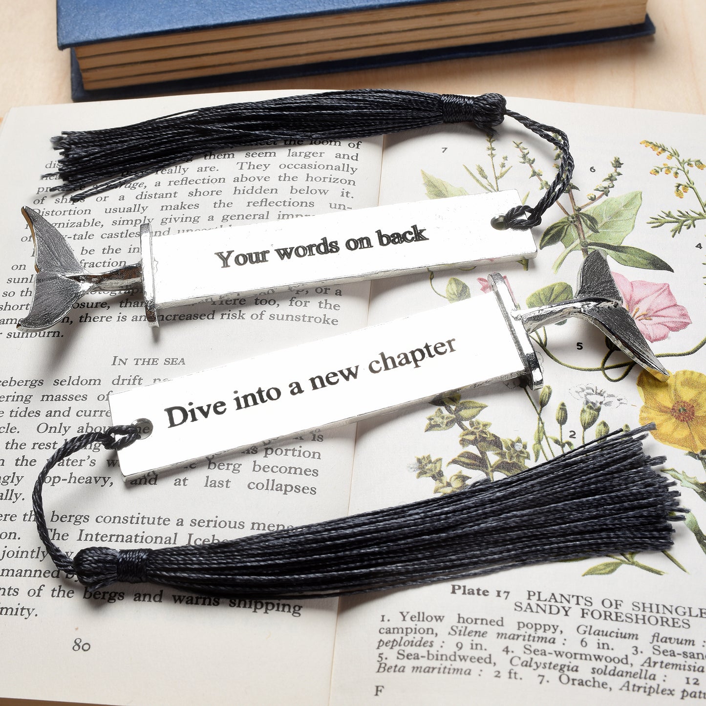 A personalised engraved pewter metal  bookmark with a diving dolphin tail on the top. On the front the quotation 'Dive into a new chapter'. New chapter gifts, dolphin gifts, personalised gifts, new job gifts. We engrave the back with your message