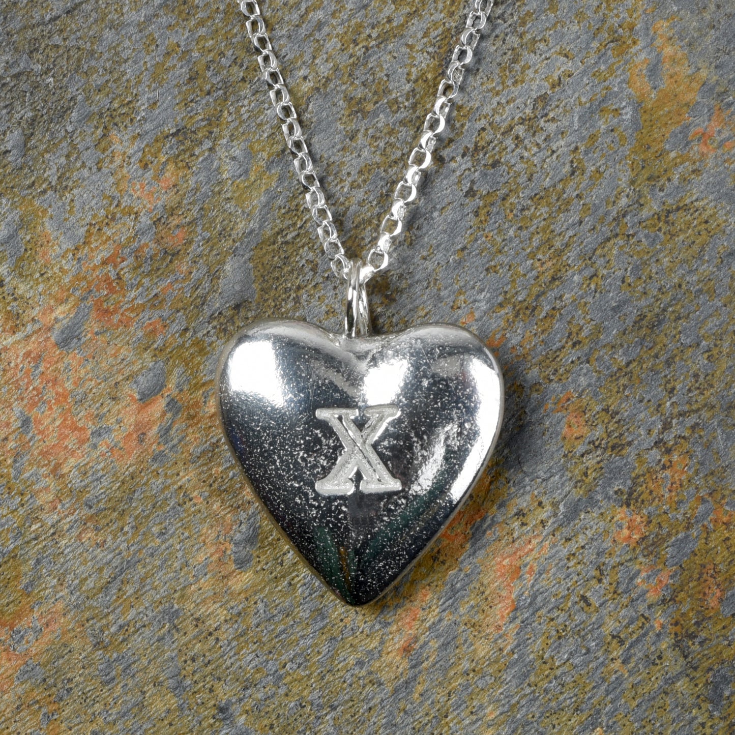 10th Anniversary gifts for her, tin gifts. A stylish and elegant pewter heart necklace with a X (signifying 10) engraved onto one side on an 18 inch Sterling silver chain.