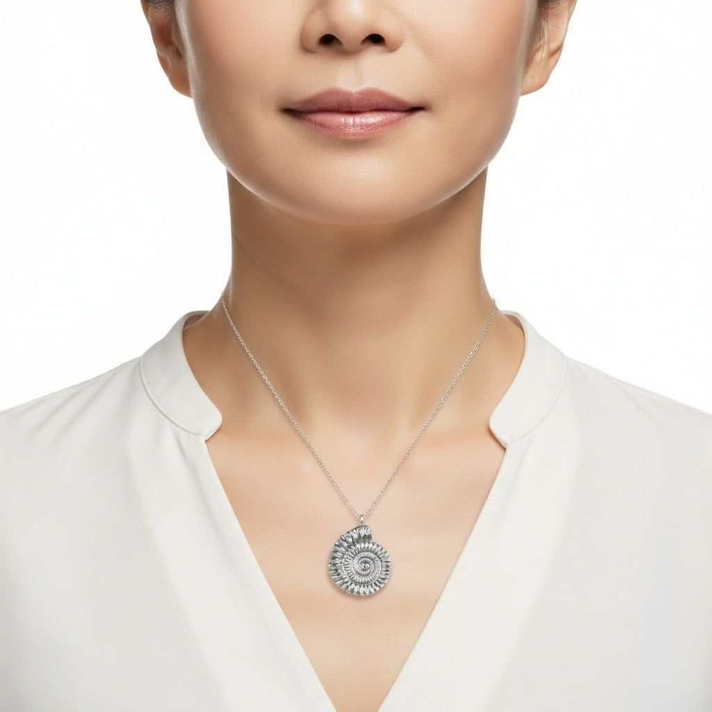 A detailed pewter ammonite fossil necklace on an 18" Sterling silver chain. Gifts for fossil lovers, ammonite nautical gifts, geology gifts. Great jewellery gifts for her. The perfect 10th tin 10 year wedding anniversary gift (Our pewter is 95% tin). Shown on a model.