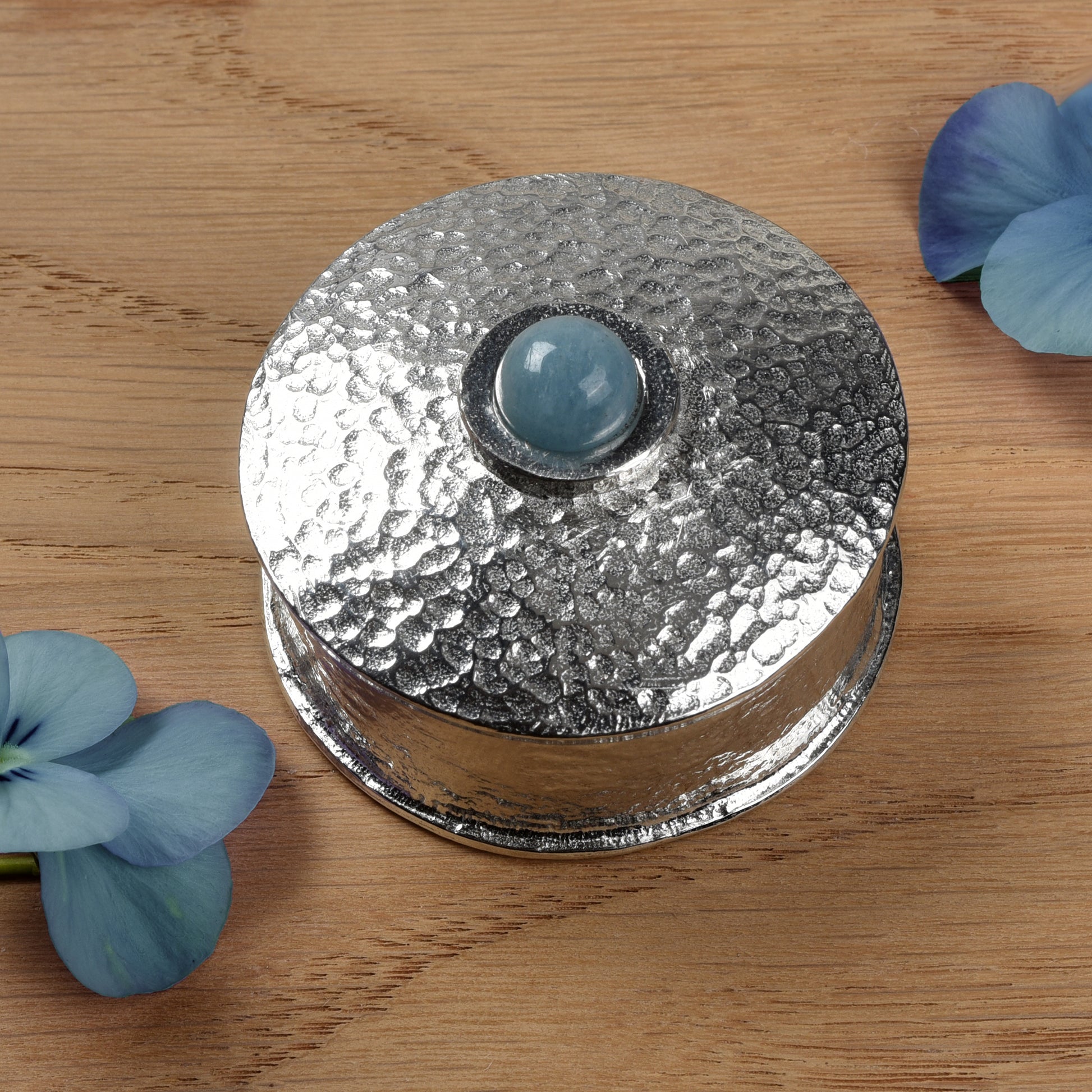 Aquamarine Birthstone Box with blue flowers on a wooden surface. March birthstone box gift. Pewter gifts handmade in the UK.