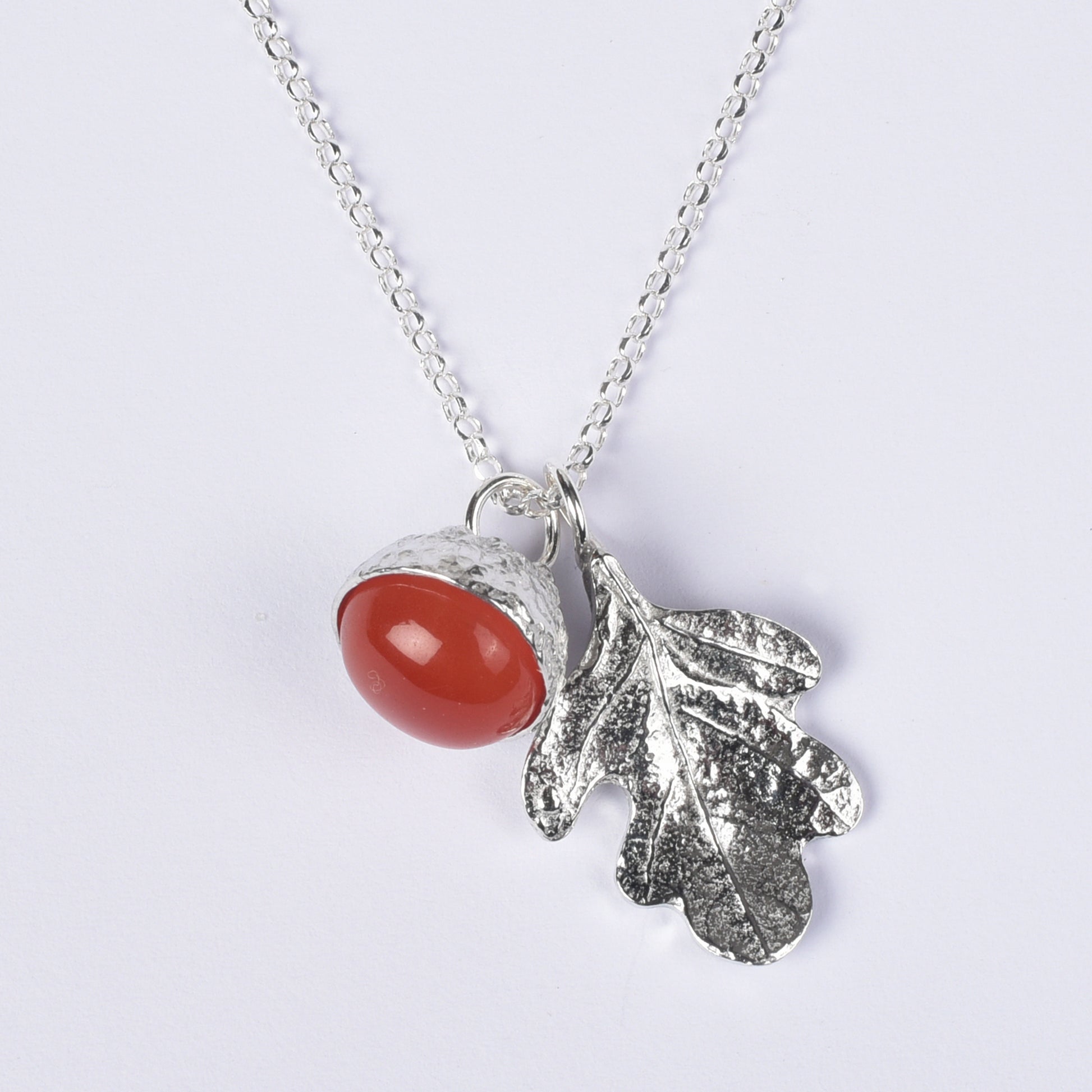 Carnelian acorn pewter necklace on a white background