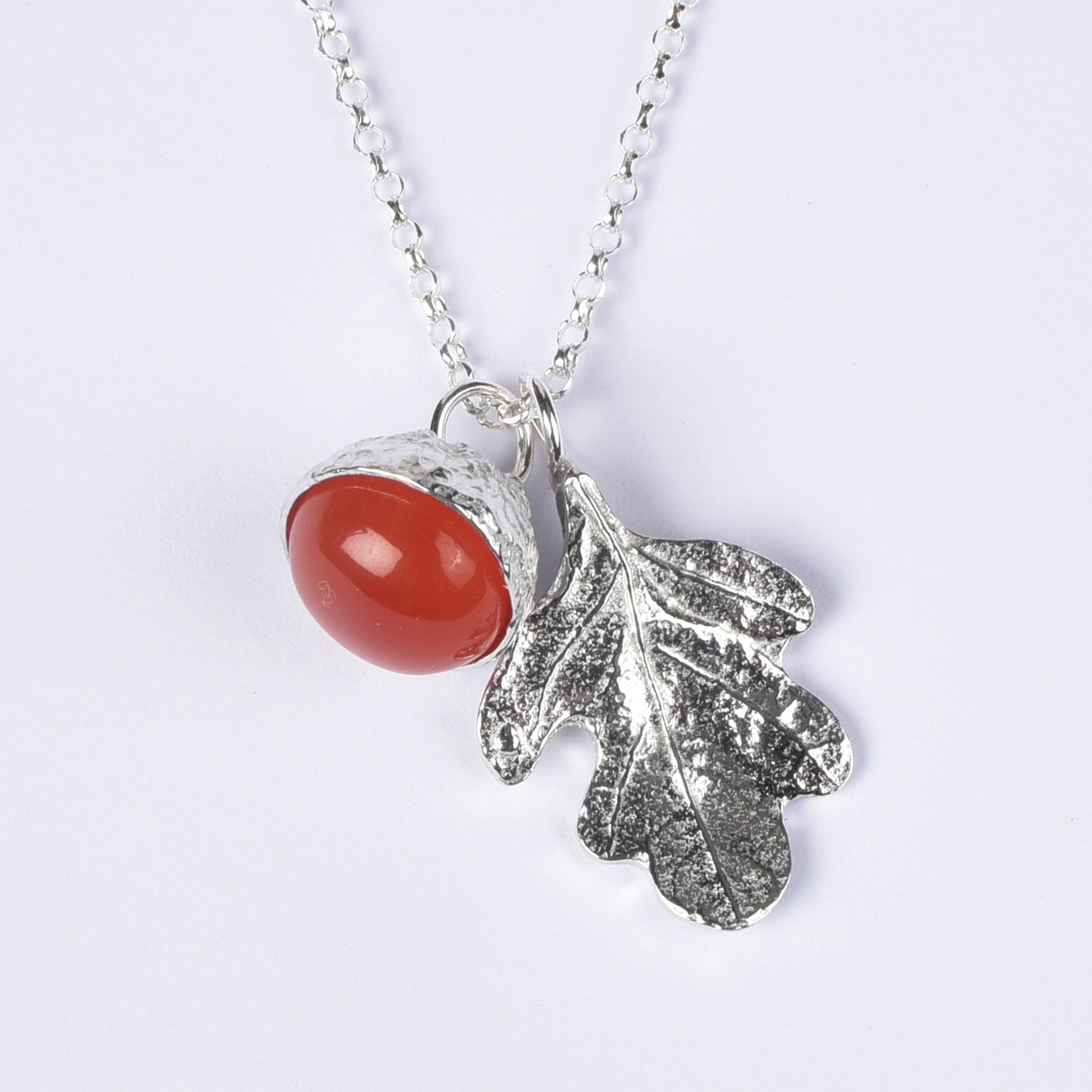 Carnelian acorn necklace on a white background