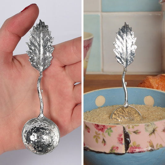 A small spoon pewter sugar spoon with a detailed chestnut leaf on the end of a twig handle. Unusual, useful and tactile gifts for nature lovers handmade in the UK