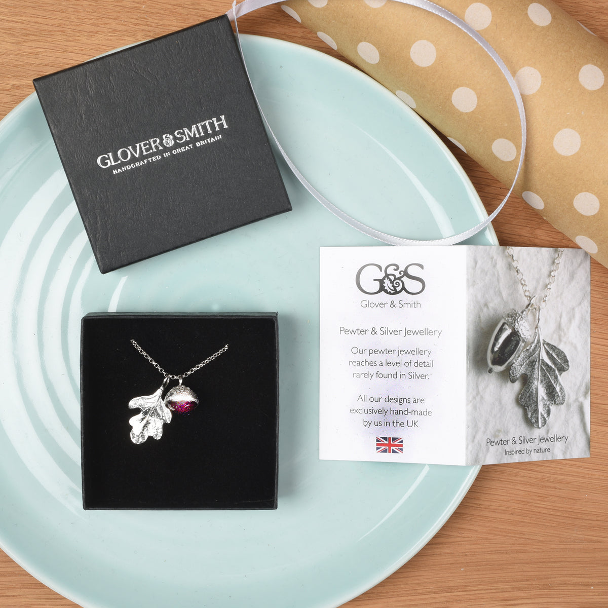 Garnet acorn and oak leaf necklace shown in Glover and Smith packaging